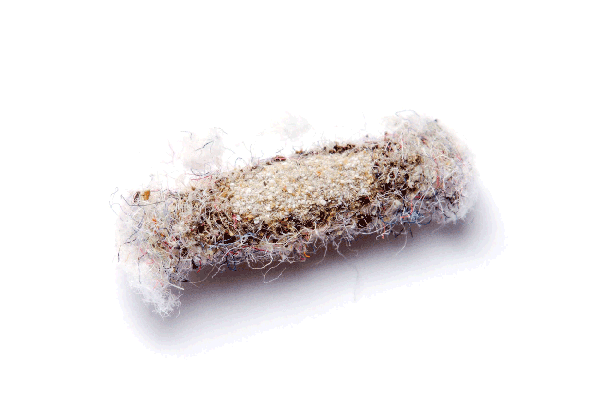 A used dryer lint trap covered with lint and debris, set against a white background.